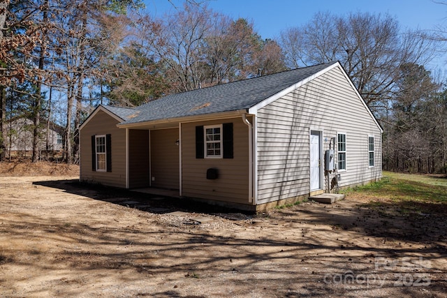 exterior space with roof with shingles