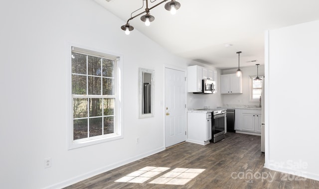 kitchen featuring range with electric cooktop, dark wood finished floors, white cabinets, stainless steel microwave, and light countertops