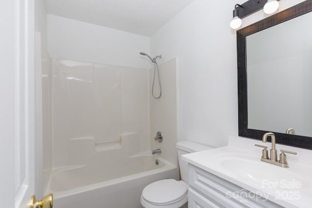 bathroom featuring shower / bathing tub combination, vanity, toilet, and a textured ceiling