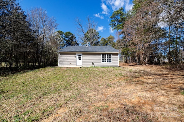 back of house with a yard