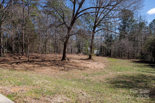 view of yard with a forest view