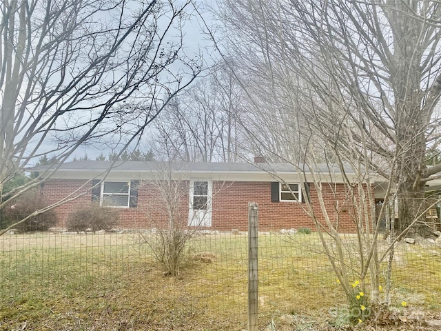 view of property exterior featuring a chimney and brick siding