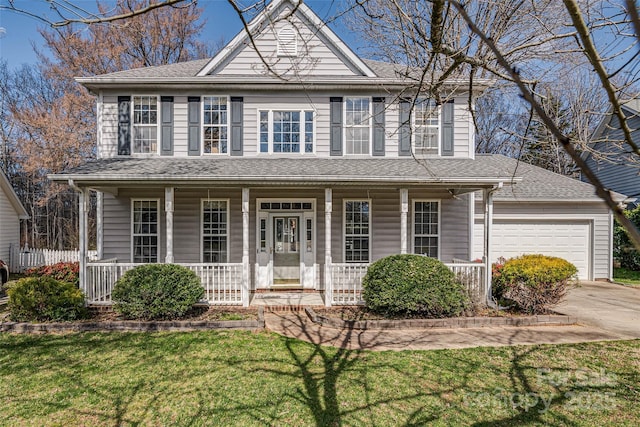 view of front of property featuring a porch, an attached garage, driveway, roof with shingles, and a front lawn