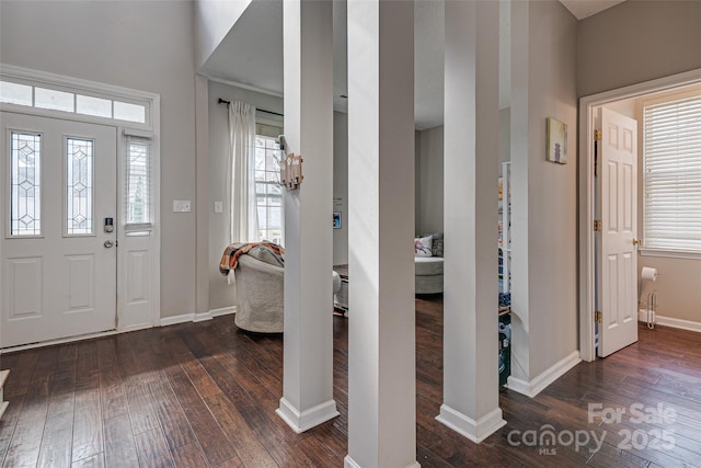 entrance foyer featuring dark wood-type flooring and baseboards