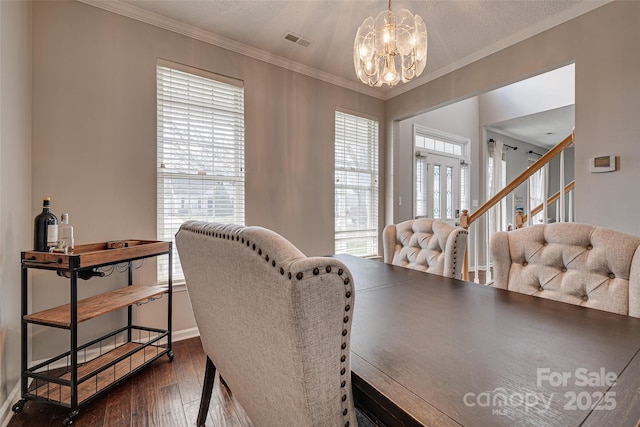 dining room featuring a healthy amount of sunlight, visible vents, dark wood-type flooring, and crown molding