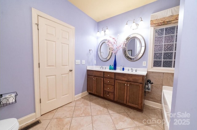 full bathroom featuring tile patterned floors, visible vents, double vanity, and a sink