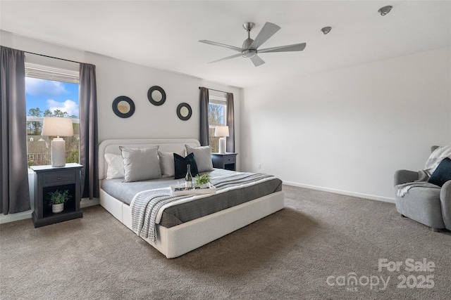 carpeted bedroom with ceiling fan, multiple windows, and baseboards