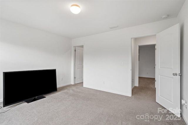 unfurnished bedroom with carpet flooring and baseboards