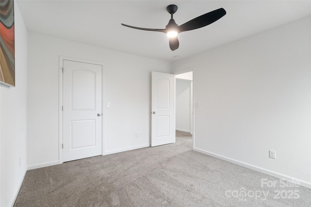 unfurnished bedroom with carpet floors, baseboards, and a ceiling fan