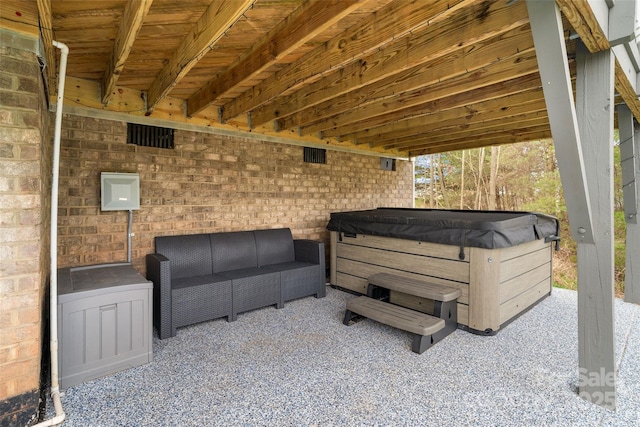 view of patio featuring outdoor lounge area and a hot tub