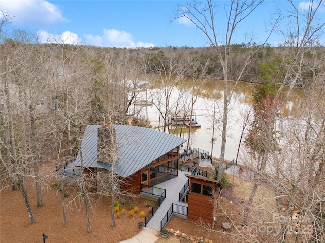 aerial view with a water view and a wooded view