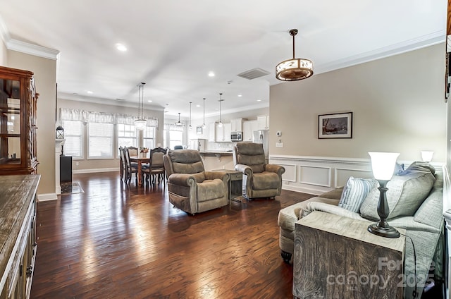 living room featuring dark wood-style floors, visible vents, ornamental molding, and recessed lighting