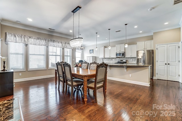 dining room featuring ornamental molding, dark wood finished floors, and visible vents