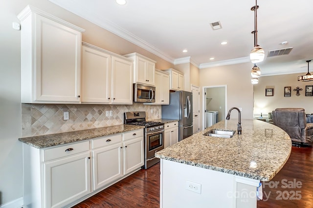 kitchen featuring visible vents, decorative backsplash, dark wood-style floors, stainless steel appliances, and a sink