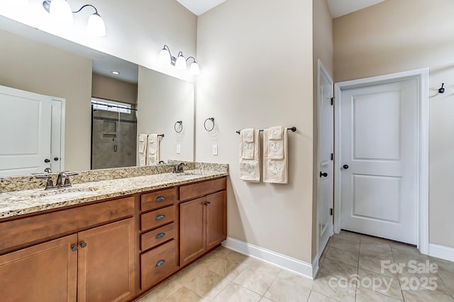 full bath featuring a shower stall, baseboards, and a sink