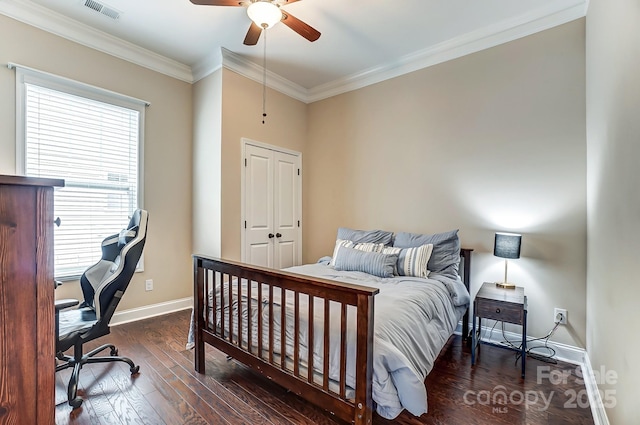 bedroom featuring crown molding, visible vents, ceiling fan, wood finished floors, and baseboards