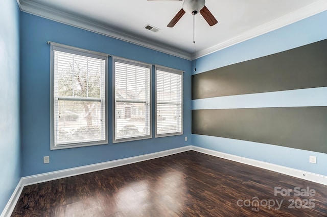 empty room with baseboards, visible vents, ornamental molding, and dark wood-type flooring