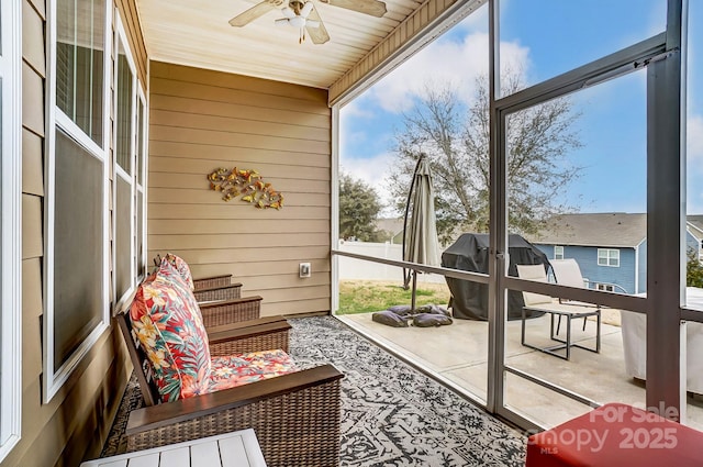 sunroom with ceiling fan and plenty of natural light