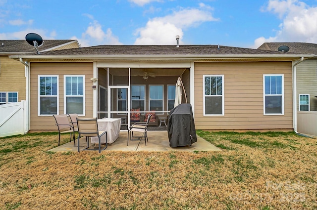 rear view of property featuring a yard, a patio area, fence, and a sunroom