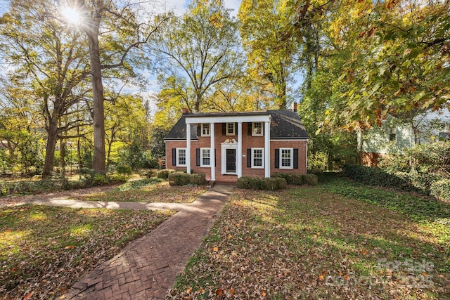 greek revival house featuring brick siding