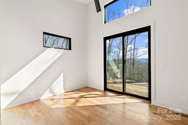 doorway to outside featuring wood finished floors and baseboards