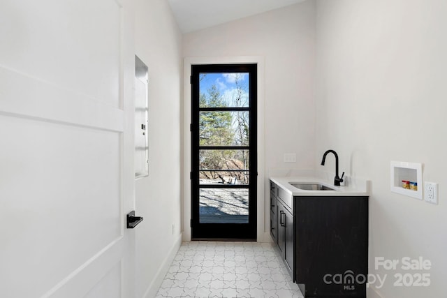 bathroom featuring lofted ceiling, vanity, and baseboards