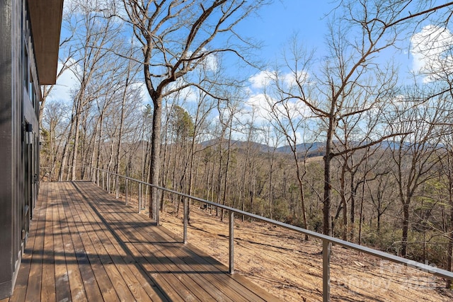 wooden deck featuring a wooded view