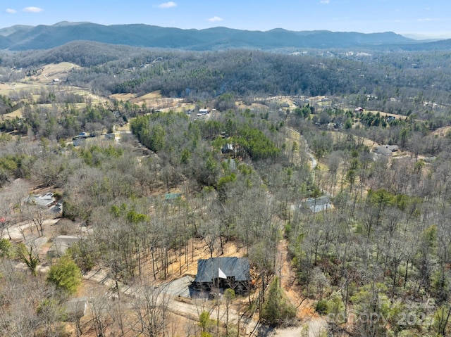 aerial view with a wooded view and a mountain view