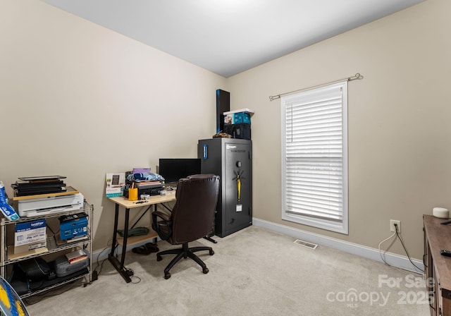 carpeted office space with baseboards and visible vents