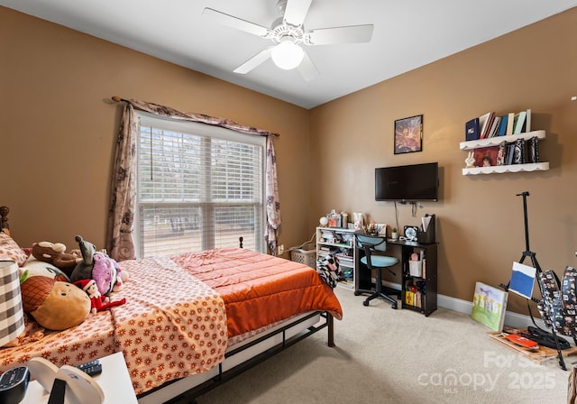 carpeted bedroom featuring baseboards and a ceiling fan