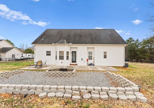 rear view of house featuring fence, an outdoor fire pit, cooling unit, a yard, and a patio