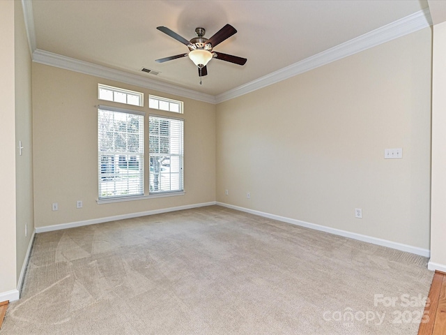 unfurnished room featuring visible vents, baseboards, light colored carpet, and ornamental molding