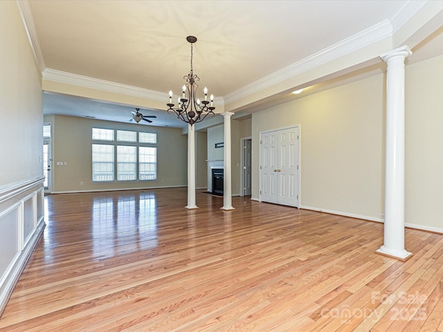 unfurnished living room featuring a glass covered fireplace, decorative columns, and light wood-style floors