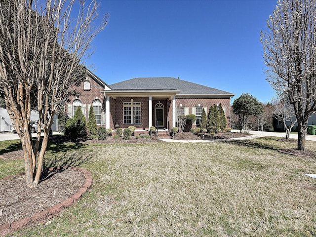 view of front of property with brick siding and a front yard