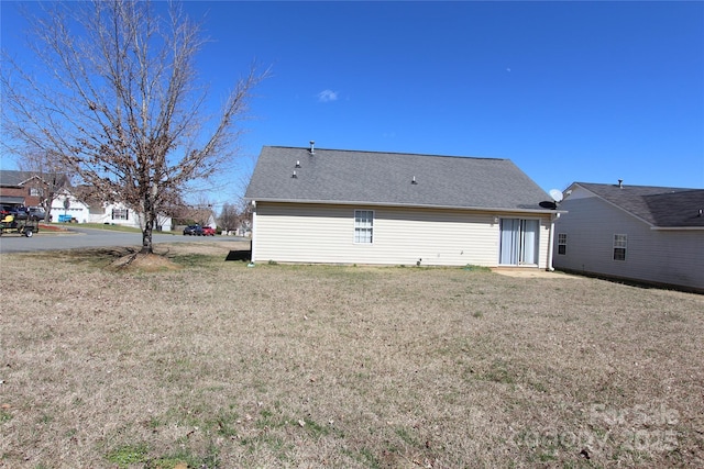 rear view of property with a yard