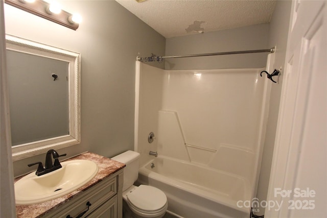 full bathroom with tub / shower combination, a textured ceiling, toilet, and vanity