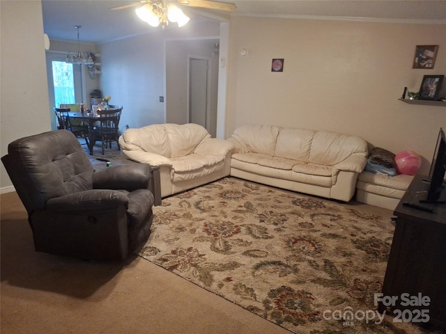 carpeted living room with crown molding and ceiling fan with notable chandelier