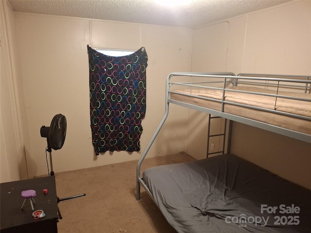 bedroom featuring a textured ceiling and carpet flooring