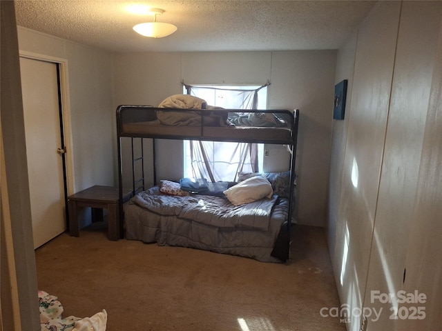 carpeted bedroom featuring a textured ceiling