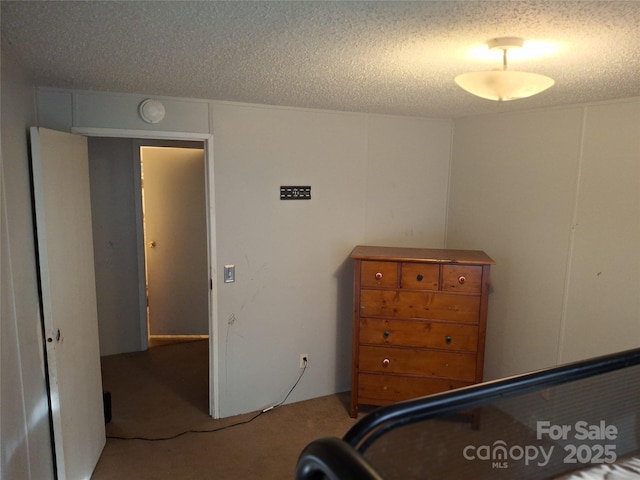 bedroom with carpet floors and a textured ceiling