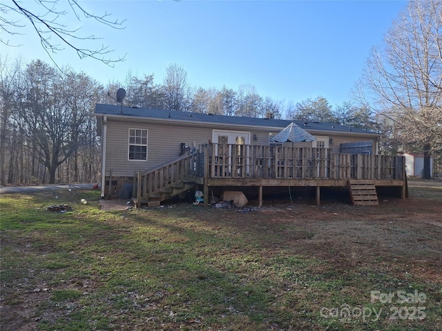 rear view of property featuring stairway and a wooden deck