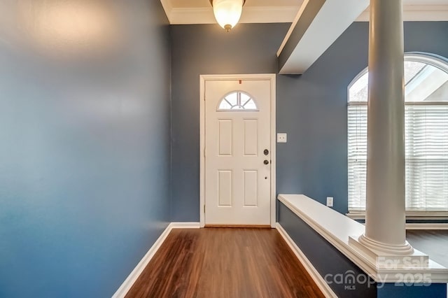 entryway with decorative columns, baseboards, and wood finished floors