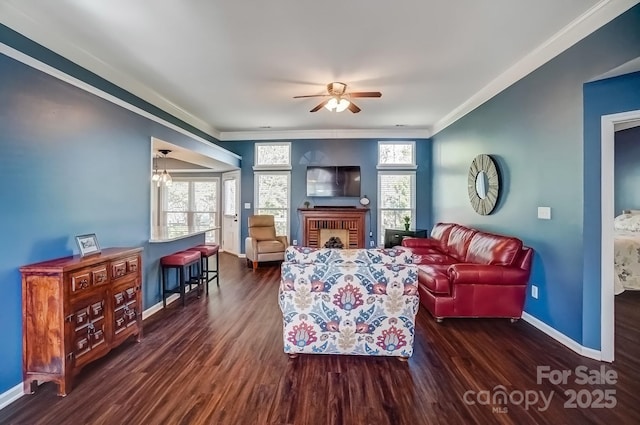 living area featuring baseboards, plenty of natural light, and wood finished floors