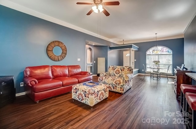 living area featuring a ceiling fan, wood finished floors, arched walkways, and baseboards