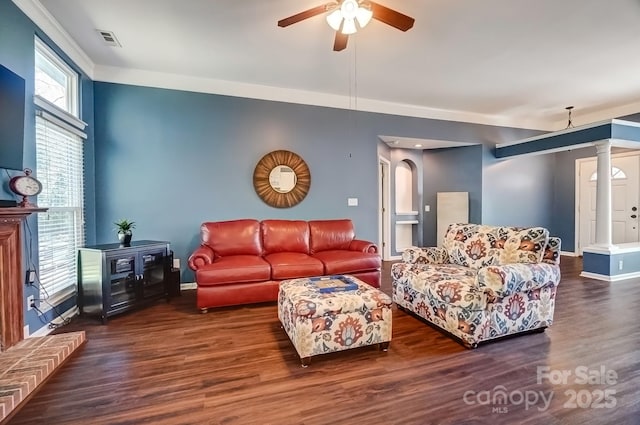 living area with visible vents, baseboards, a ceiling fan, and wood finished floors