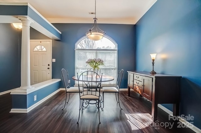 dining area featuring decorative columns, baseboards, visible vents, and dark wood-style flooring