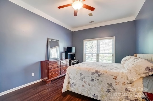 bedroom featuring dark wood finished floors, baseboards, visible vents, and ceiling fan