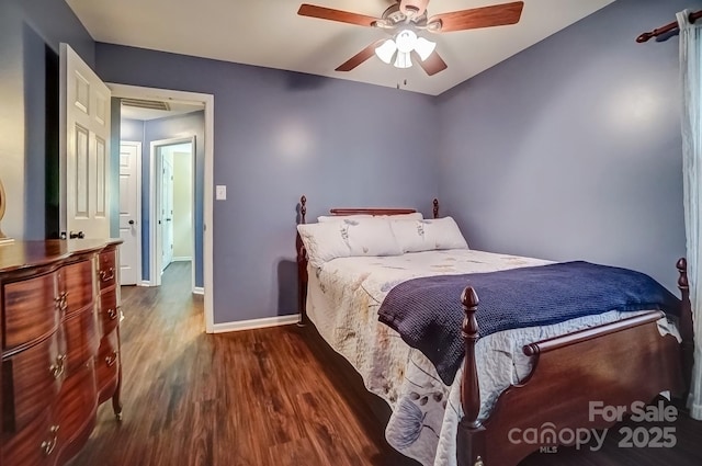 bedroom with ceiling fan, baseboards, attic access, and wood finished floors