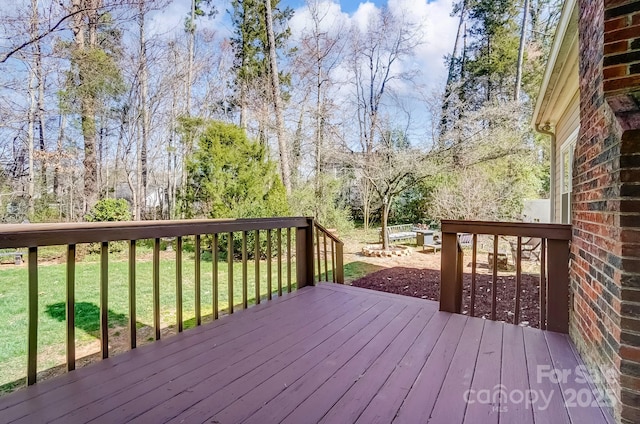 wooden deck with a lawn