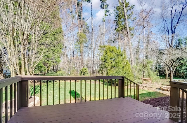 wooden deck with a lawn